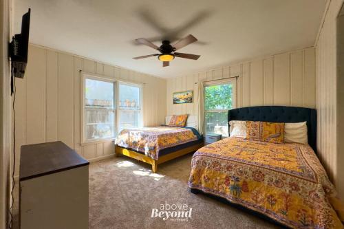 a bedroom with two beds and a ceiling fan at The Updated Aviator - Minutes to Everything Wichita Falls, TX in Wichita Falls