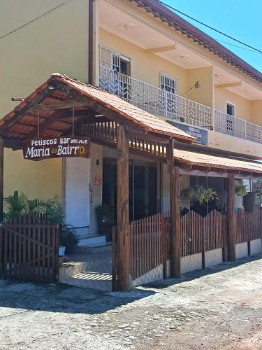 a building with a wooden fence in front of it at Maria do Bairro in Guaraciaba do Norte