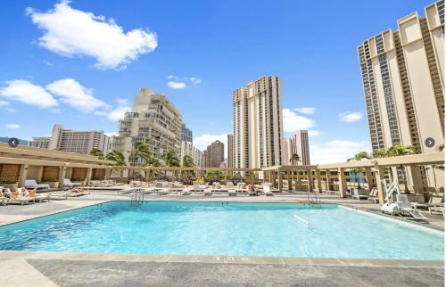 a swimming pool in a city with buildings at Ala Moana Condo Hotel in Honolulu