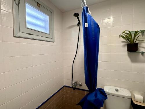 een blauw douchegordijn in een badkamer met een toilet bij Puerto Rico Sea & Sun in Puerto Rico de Gran Canaria