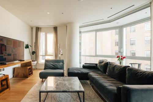 a living room with a couch and a coffee table at LUXURY 3 Bed 3 Bath Apartment in Central London in London