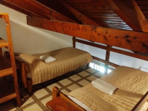 a room with two bunk beds in a house at Las Rosas EH in El Hoyo