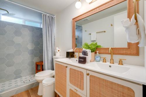 a bathroom with a sink and a toilet and a mirror at 2 Mi to Dtwn Gorgeous Gilbert Gem with Private Yard in Gilbert