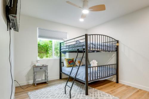 a bedroom with bunk beds in a room with a ceiling fan at 2 Mi to Dtwn Gorgeous Gilbert Gem with Private Yard in Gilbert