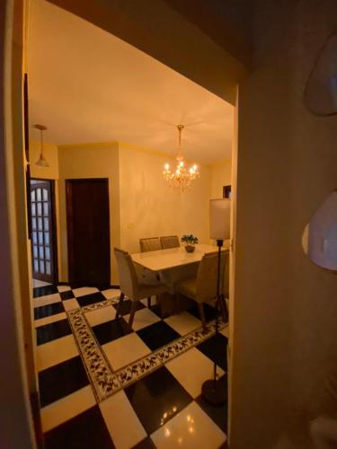 - une salle à manger avec une table et un sol en damier dans l'établissement Casa azul, à Caçapava