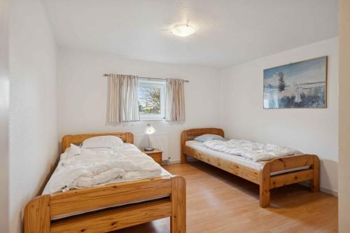 a bedroom with two beds and a window at Calm Holiday Home With Great Outings in Kollund