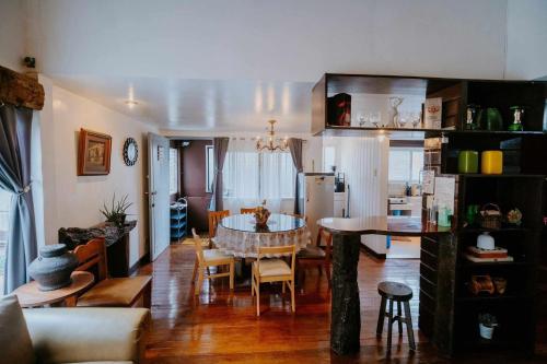 a living room with a table and a kitchen at Classic, Cozy House for Transient in Baguio City 1 in Baguio