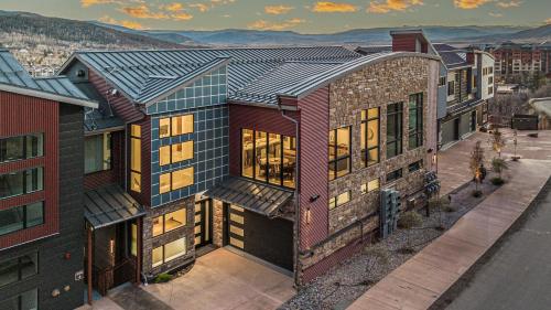 an aerial view of a house with mountains in the background at Crescendo Crest in Steamboat Springs