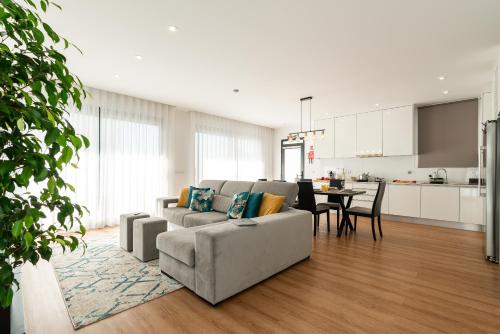 a living room with a couch and a table at Villa Fenix II by Madeira Dream Stays in Câmara de Lobos