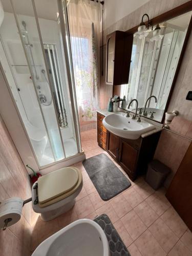 a bathroom with a toilet and a sink and a shower at Casale Kintsugi in Cepagatti