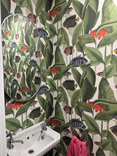 a bathroom with a floral wallpaper with a sink at 4 bedroom house sleeps 8 next to Aviva Stadium and Landsdown Stadium in Dublin