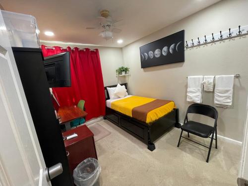 a small room with a bed and a television at Room R1 with tempurpedic mattress and top facilities in San Jose