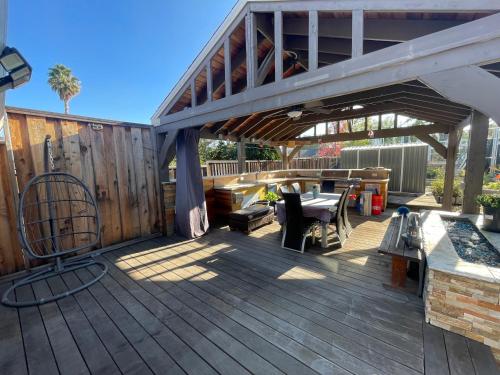 a wooden deck with a picnic table and awning at Room R1 with tempurpedic mattress and top facilities in San Jose