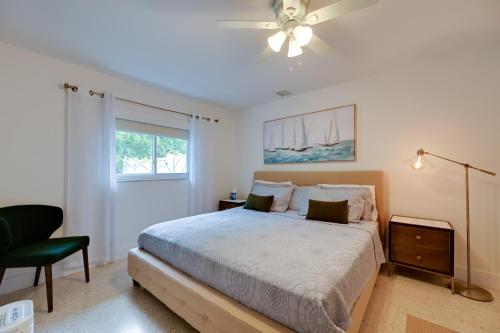 a bedroom with a bed and a chair and a window at Sunny Florida Escape with Patio, Grill and Fire Pit! in Naples