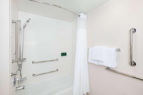 a bathroom with a shower and a bath tub at Sonesta ES Suites Atlanta Alpharetta Windward in Alpharetta