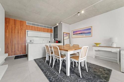 a kitchen and dining room with a table and chairs at Premium Bondi Beach 2 Bedroom with Beach view and parking in Sydney