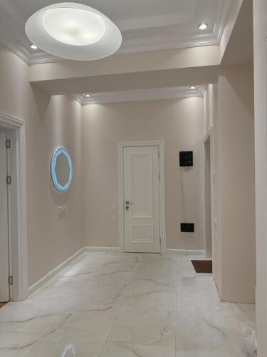 pusty pokój z białą ścianą i białymi drzwiami w obiekcie White City Apartment w mieście Baku