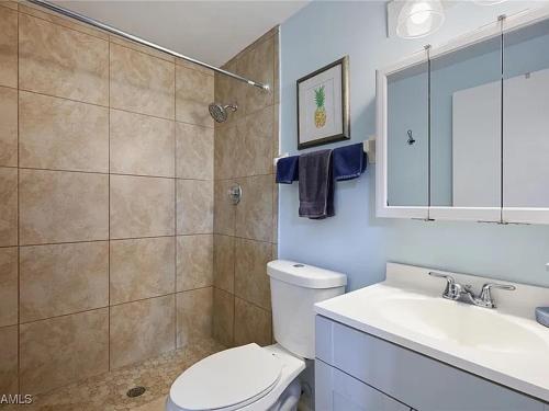 a bathroom with a toilet and a sink and a shower at Cypress Retreat Cozy Ft Myers Pet Friendly Home in Fort Myers