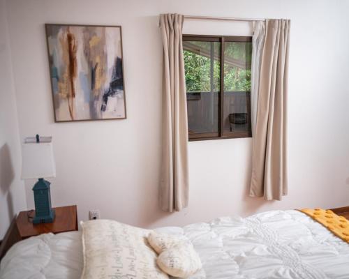 Una cama o camas en una habitación de Hotel La Pérgola