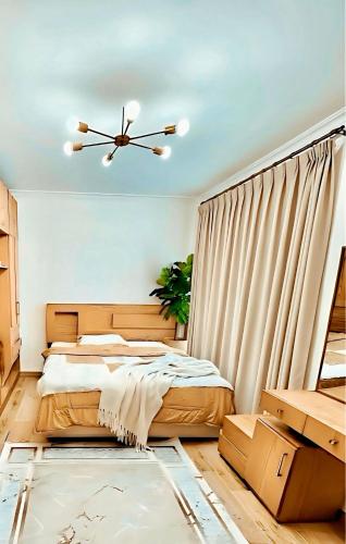 a bedroom with a bed and a ceiling fan at Elegant Apartment at Sheikh Zayed Compound in Sheikh Zayed