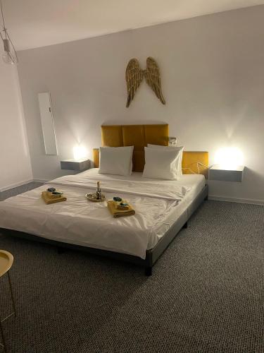 a bedroom with a large bed with two trays on it at Gold Angel in Poznań