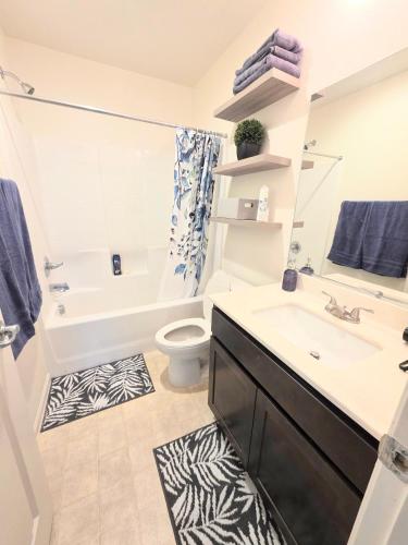 a bathroom with a sink and a tub and a toilet at 2-Bedroom Entire Guest Suite in North Las Vegas Mountain Views in Las Vegas