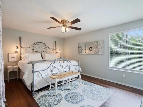 a bedroom with a bed with a ceiling fan at Cypress Retreat Cozy Ft Myers Pet Friendly Home in Fort Myers