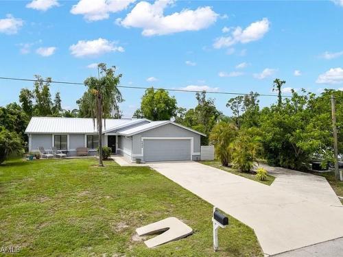 a house with a yard with a driveway at Cypress Retreat Cozy Ft Myers Pet Friendly Home in Fort Myers