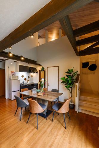a kitchen and dining room with a table and chairs at 美ら海かふうテラス in Motobu