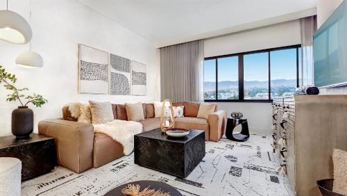 a living room with a couch and a table at Huntley Santa Monica Beach in Los Angeles
