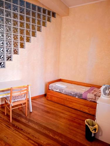 a room with a bed and a chair in it at A un passo dal centro gli orsetti del duomo in Piacenza