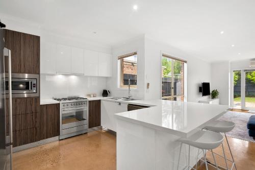 Geelong WestMia's Place Modern Pet friendly Geelong West stay的白色的厨房,配有大型白色台面