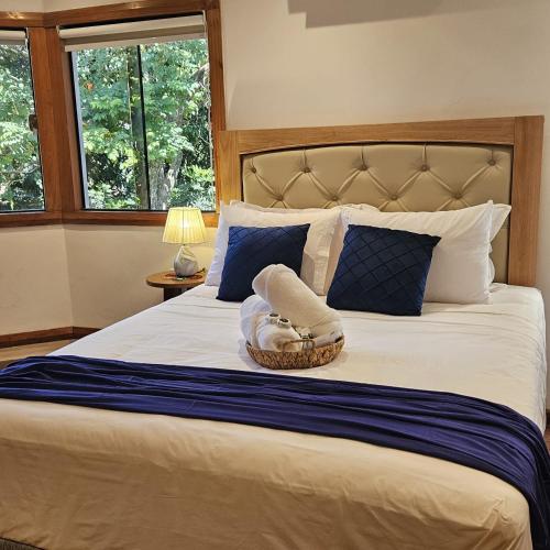 a bedroom with a large bed with a basket on it at Green Palace Hotel Boutique in Asunción