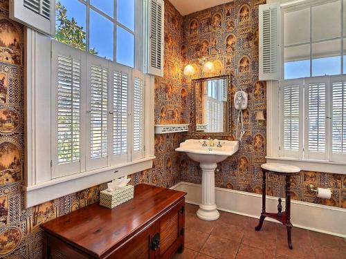 un bagno con lavandino e specchio di Bird Baldwin Forsyth Suite a Savannah