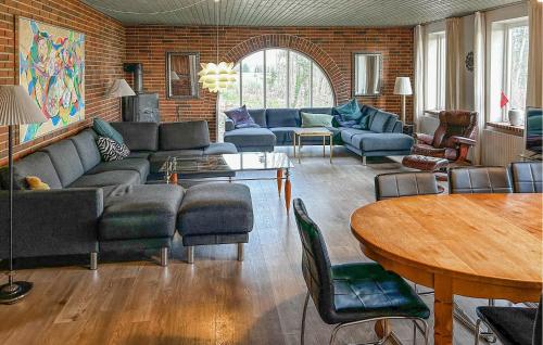 a living room with a couch and chairs and a table at Hellehave in Ravnholt