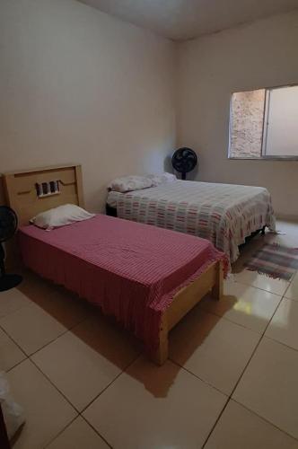 a room with two beds in a room at Casa da Meire in Prado