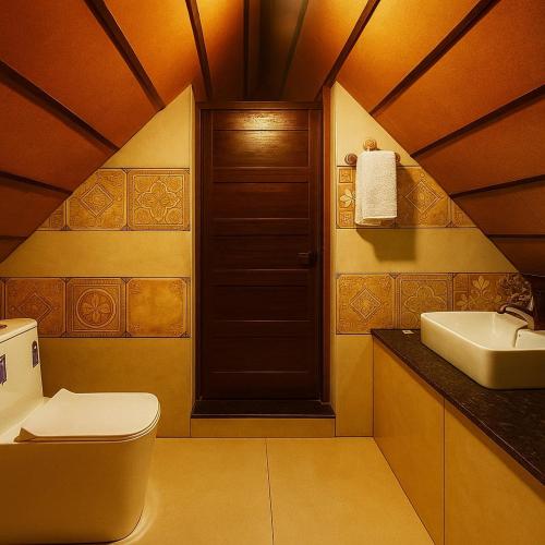 a bathroom with a toilet and a sink at Senthamarai villa in Sultan Bathery