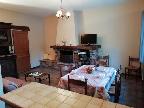 a living room with a table and a fireplace at Charming Chalet with Swimming Pool in Quend in Quend