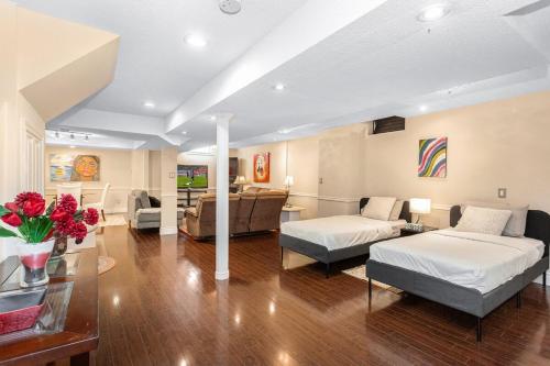 a living room with two beds and a couch at Spacious 5BR Retreat with Private Suite Sleeps 12 in Mississauga