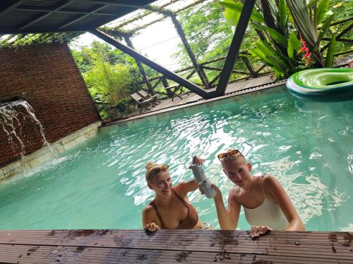 two women in a swimming pool at Homestay ECO MAY5 TRAVEL in Ha Long