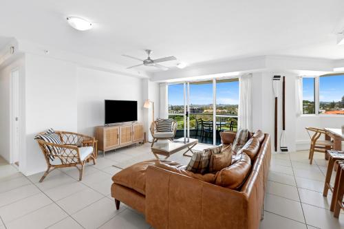 a living room with a couch and a television at ULTIQA Points North in Gold Coast