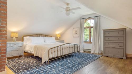 a bedroom with a bed and a dresser and a window at Cordelia by AvantStay Amazing Backyard 10mins from Stockbridge in Lee