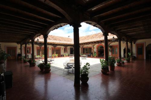 a courtyard with potted plants in a building at Hotel Diego de Mazariegos in San Cristóbal de Las Casas