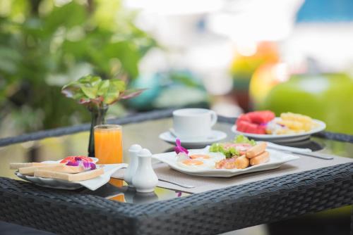 een tafel met twee borden met ontbijtproducten erop bij Bay Beach Resort Jomtien in Jomtien Beach