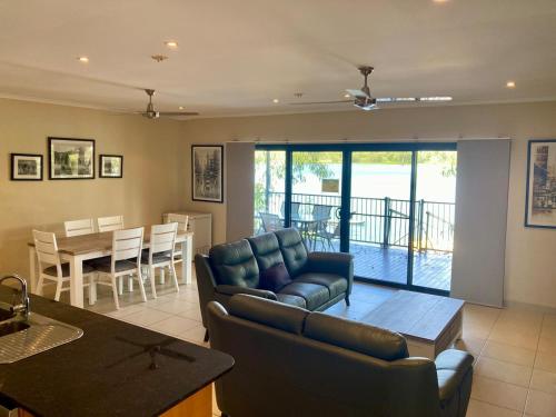 a living room with a couch and a table at Black Wattle Bungalow 30 Lake Bennett in Lake Bennett