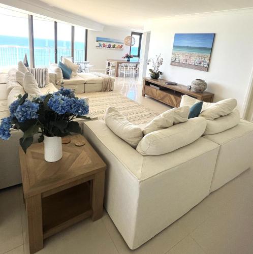 a living room with two couches and a table at The Breakers in Gold Coast