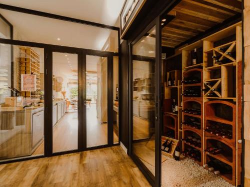 a wine cellar with glass doors and a room with wine racks at Mercure Annecy Sud in Annecy