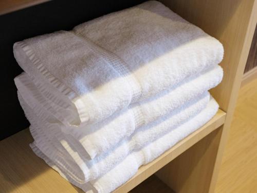 a stack of towels sitting on a shelf at Disney Style Hotel "J Hotel" - Vacation STAY 17207v in Chiba