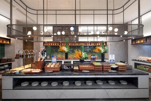 a bakery with a counter with food on display at Hampton by Hilton Cixi Guanhaiwei in Ningbo