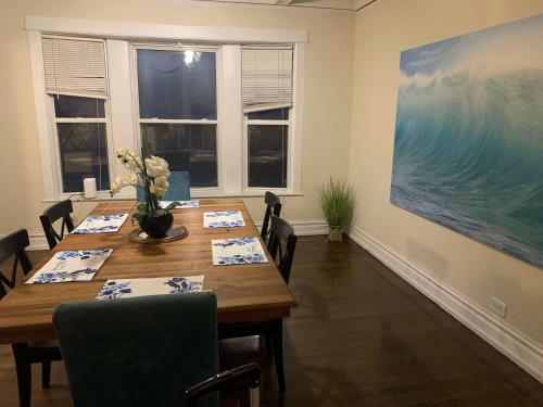 a dining room with a table and a large painting at North Chicago Spacious Home in Chicago